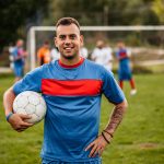 Portrait of soccer player on football field holding a ball. – © urbazon - istockphoto.com - 1310476853